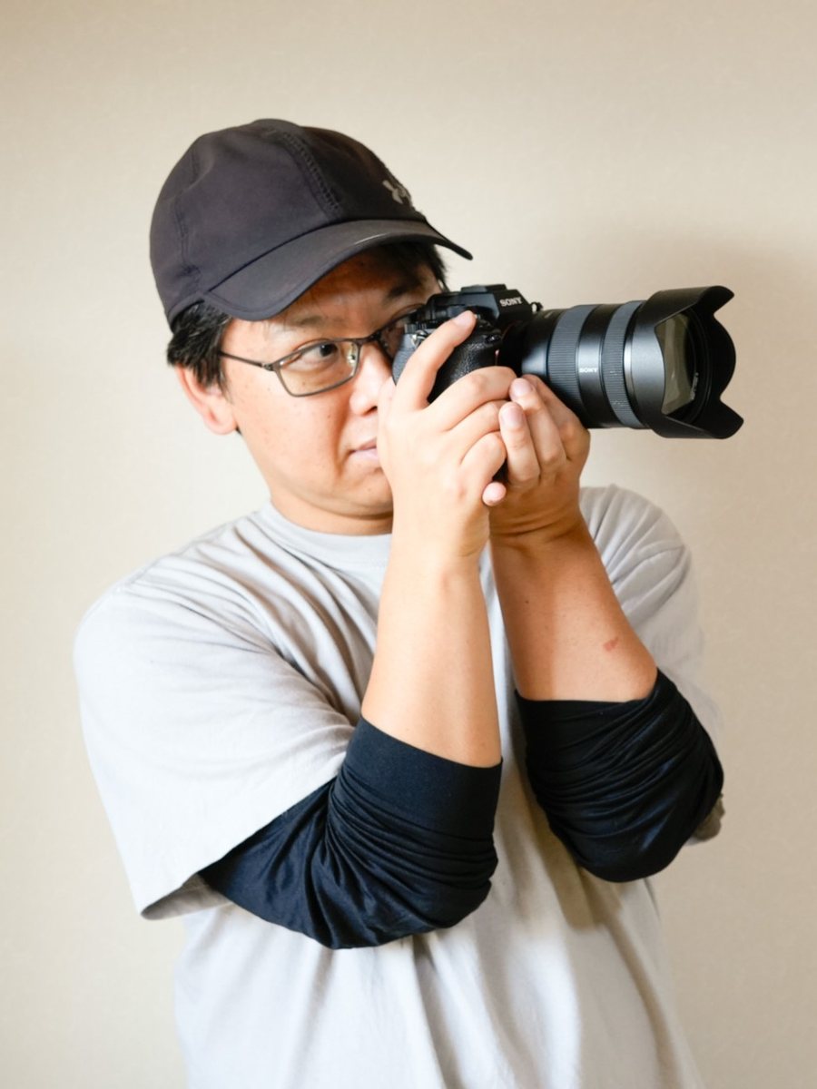 カメラのファインダーを覗く長谷川敬介